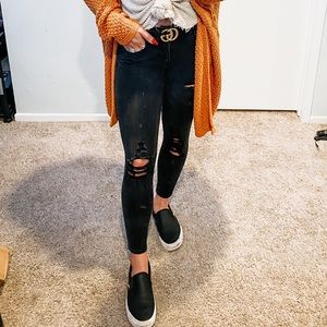 Distressed black skinny jeans